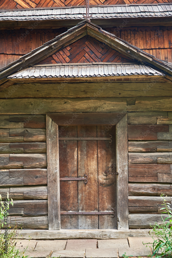 The facade of a wooden building with a door