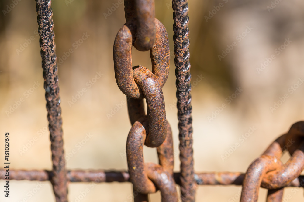 Rusty chain on an old metal fence Rusty chain on an old metal fence