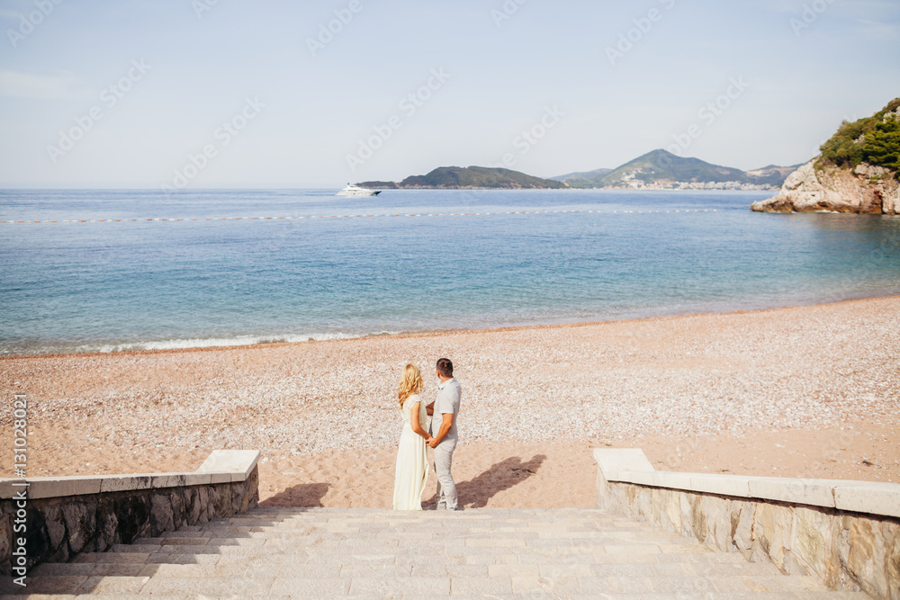 lovely couple relax on beach together lovely couple relax on beach together