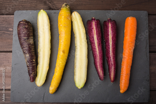 Fresh organic rainbow carrots on a wooden table