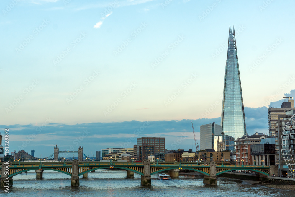 Fototapeta premium Londyn, Anglia - 17 czerwca 2016: Zmierzch na moście Southwark, Tamiza i wieżowiec The Shard, Londyn, Wielka Brytania