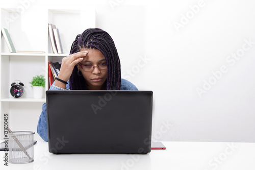 thoughtfully working with the portable computer women photo