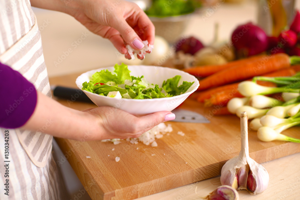 Young Woman Cooking in the kitchen. Healthy Food Young Woman Cooking in the kitchen. Healthy Food