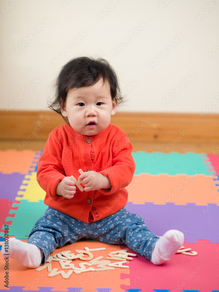 Asian baby girl learning English letters Asian baby girl learning English letters