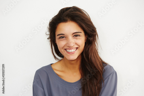 beautiful female smiling against white background. © mimagephotos