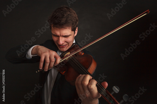 Fotografija Man playing violin showing emotions and expressions