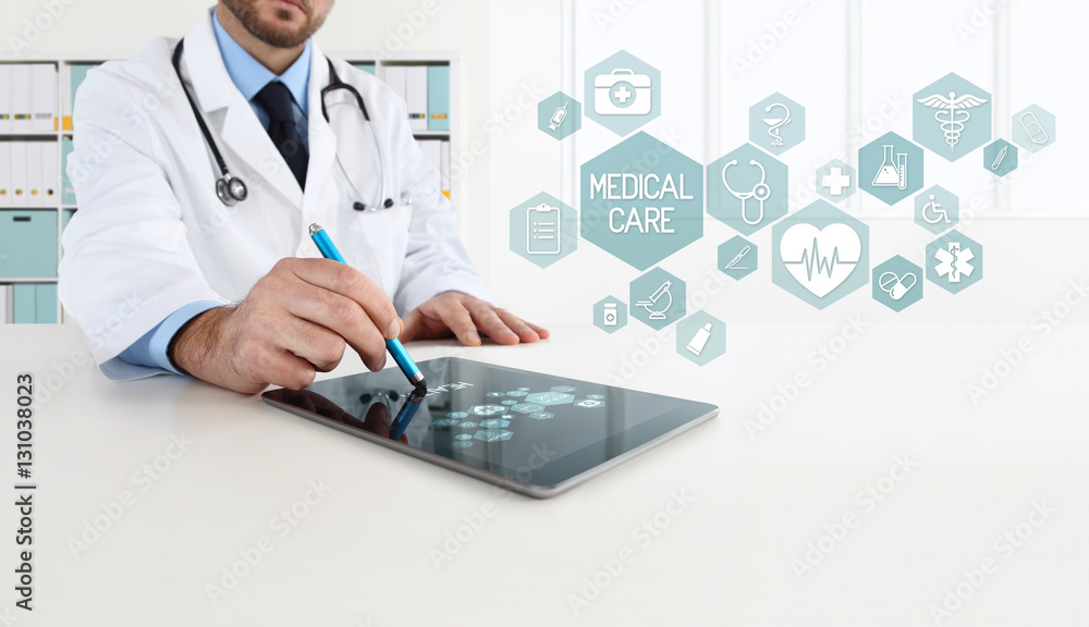 doctor uses the tablet with icons, in office desk doctor uses the tablet with icons, in office desk