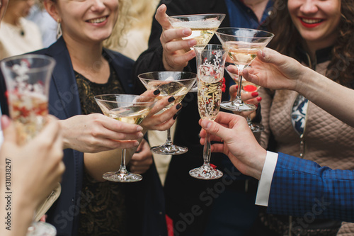 Hands holding glasses and toasting, happy festive moment, luxury
