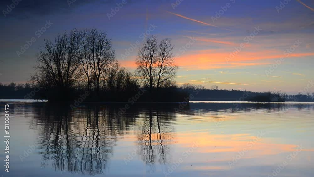 Sunset over a lake with small islands at the end of a winter day. Sunset over a lake with small islands at the end of a winter day.