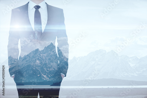 Canvas Print Businessman on mountains background multiexposure