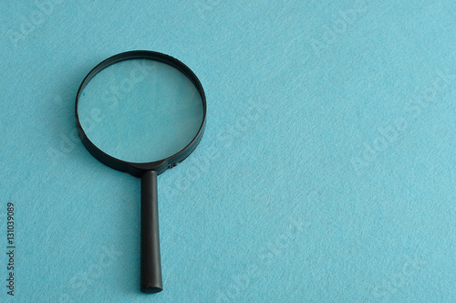 Magnifying glass isolated on a blue background