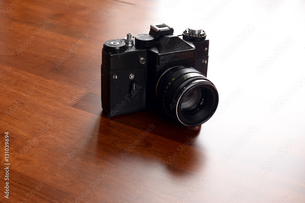 retro camera on a background of brown wooden table
