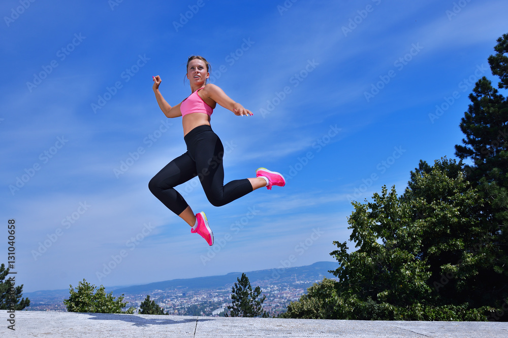 Young woman joyfully jumping in Park Young woman joyfully jumping in Park