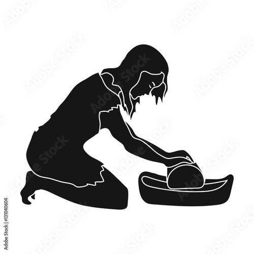 Cavewoman with grindstone icon in black style isolated on white background. Stone age symbol stock vector illustration.