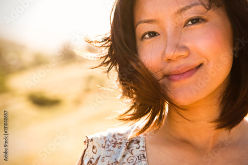 Close portrait of a young asain woman outdoors