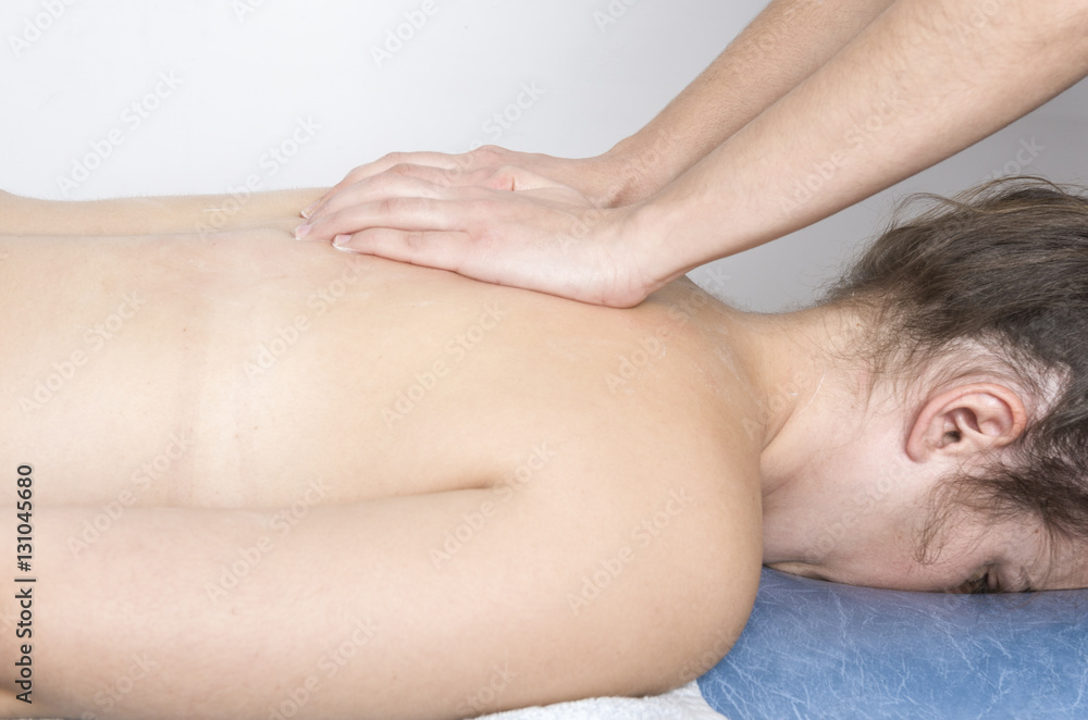 Physiotherapist, chiropractor giving a massage to a patient. Physiotherapist, chiropractor giving a massage to a patient.