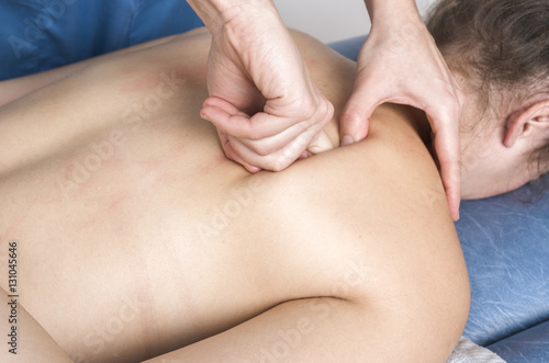 Physiotherapist, chiropractor giving a massage and stretching of