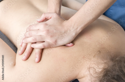 Physiotherapist, chiropractor giving a massage to a patient.