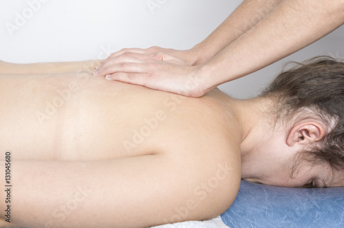 Physiotherapist, chiropractor giving a massage to a patient.