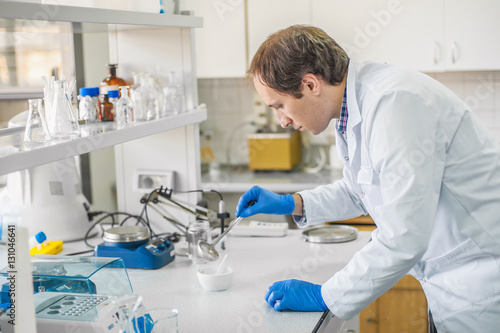 Male laboratory researcher performs tests