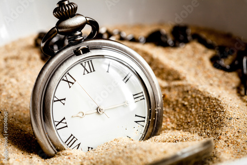 deadline concept pocket watch in sand background