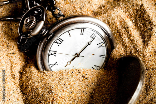 deadline concept pocket watch in sand background