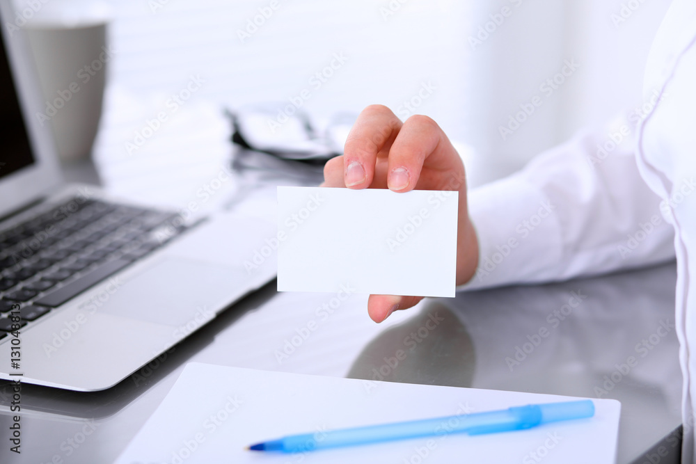 Close-up of business woman giving a visit card Close-up of business woman giving a visit card