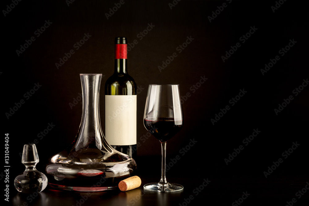 red wine bottle glass cork carefe on plain black background