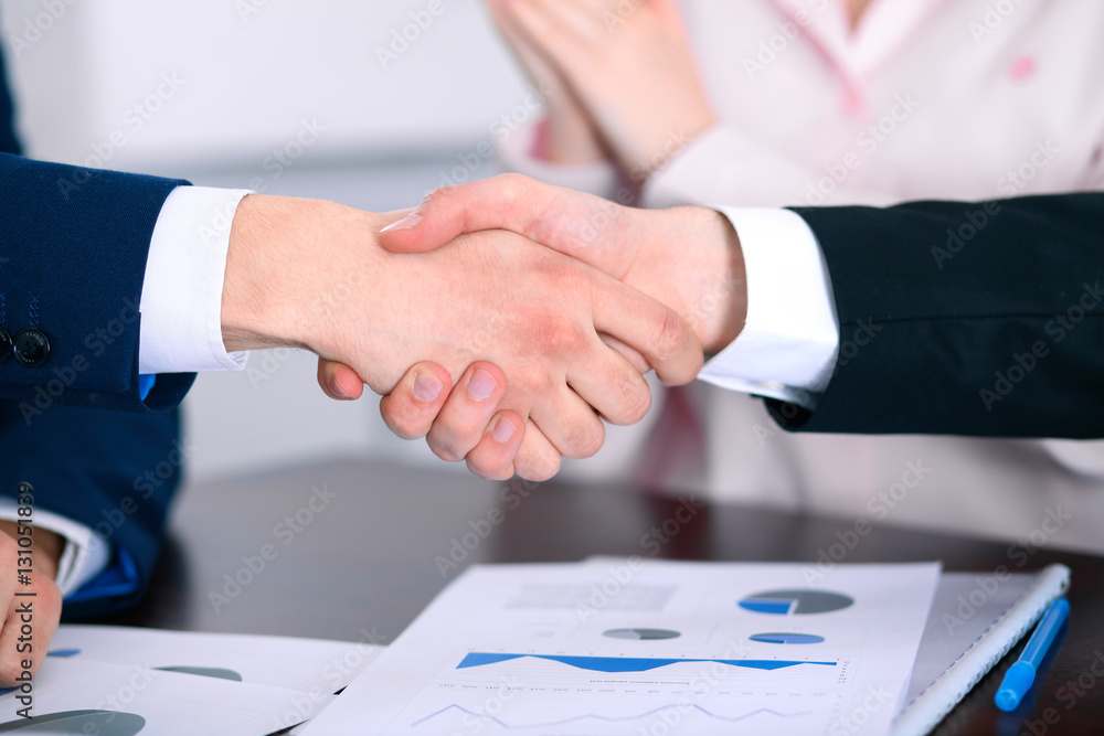 Business people shaking hands finishing up a meeting Business people shaking hands finishing up a meeting