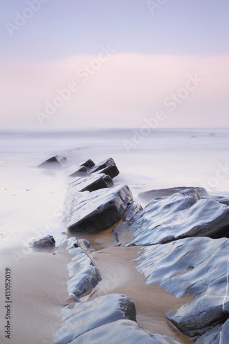 Serene seascape in Barrika beach, Biscay, Basque Country, Spain. Long exposure on a very cloudy day.