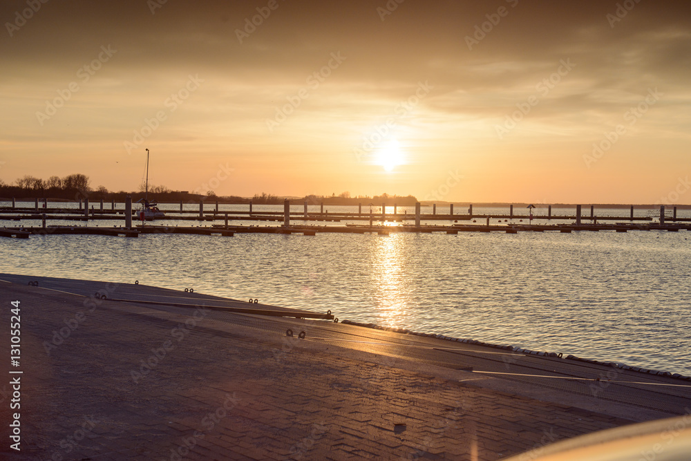 Yacht port over orange sunset