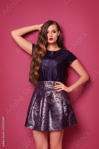 Trendy look. Gorgeous young woman on pink background