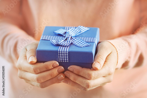 Fototapeta Naklejka Na Ścianę i Meble -  Female hands holding gift box, closeup