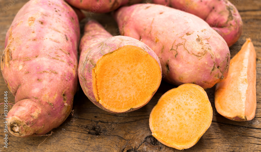 fresh sweet potatoes on wooden table fresh sweet potatoes on wooden table