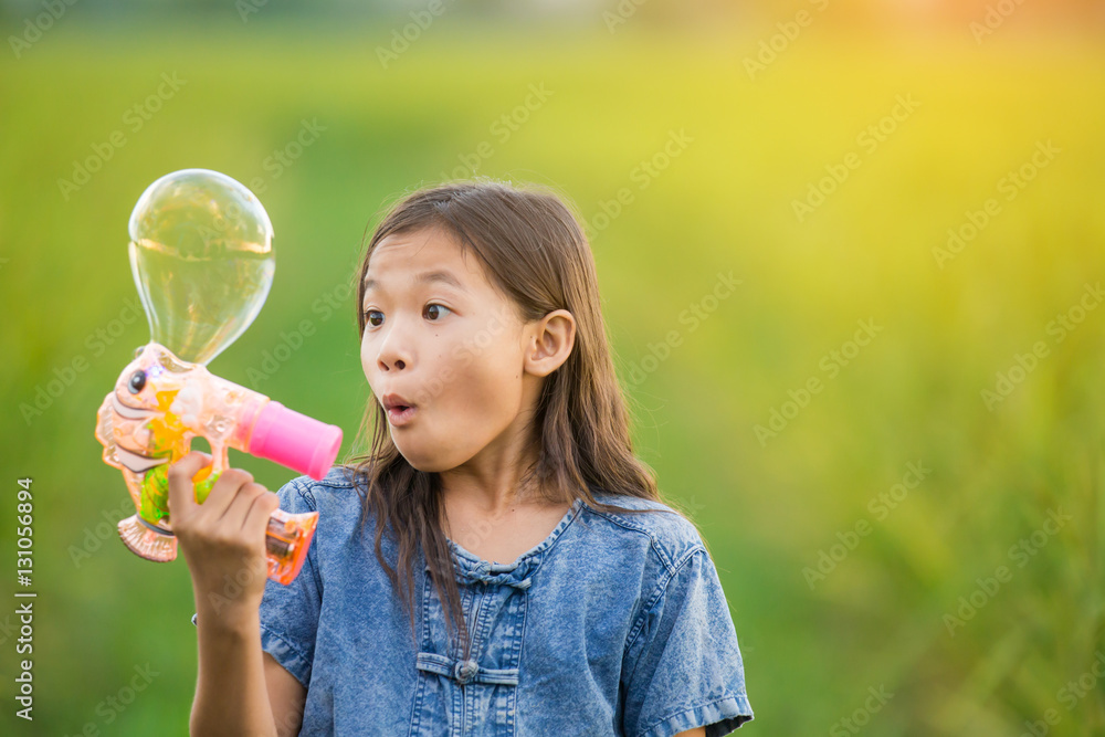 Portrait of asian girl blowing soap bubbles Portrait of asian girl blowing soap bubbles