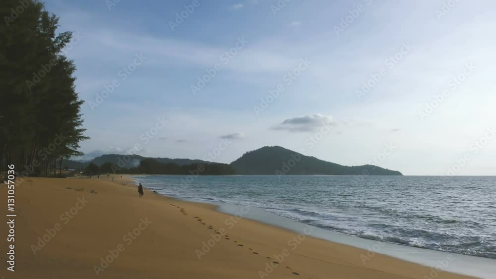 Unrecognizable man walking along beach Unrecognizable man walking along beach