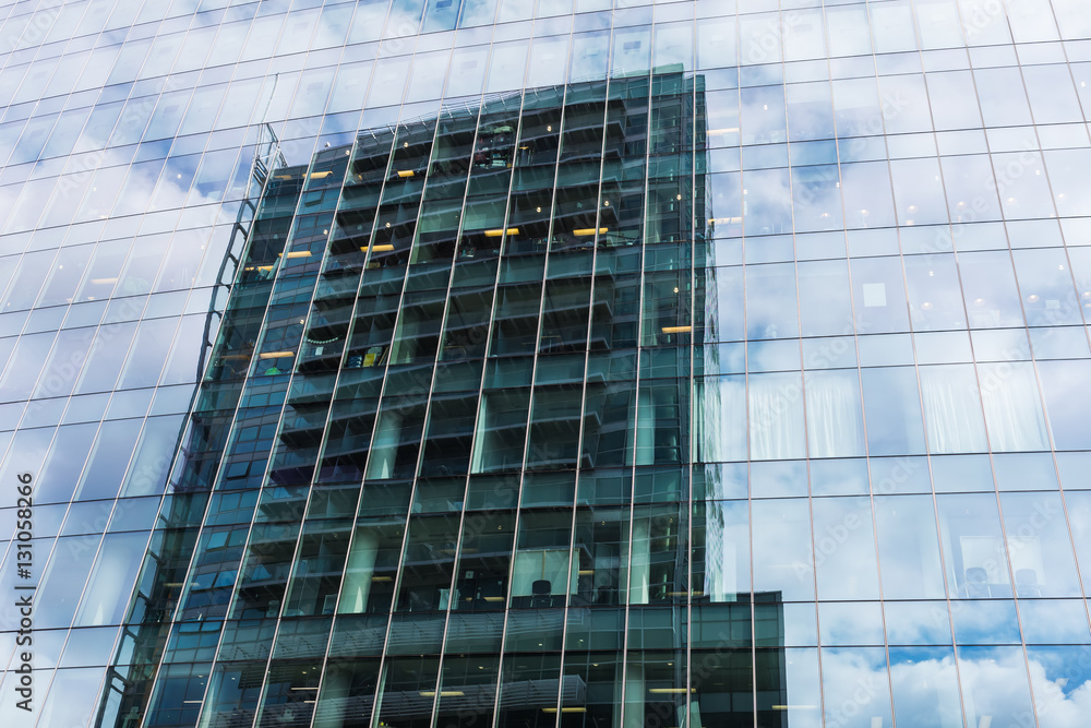 office building reflecting in a glass facade