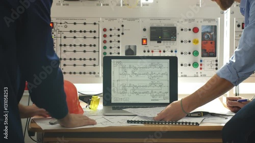 Engineer and foreman working at control room of a modern thermal power plant