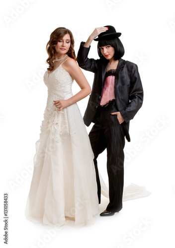 Female gay couple dressed like groom and bride standing