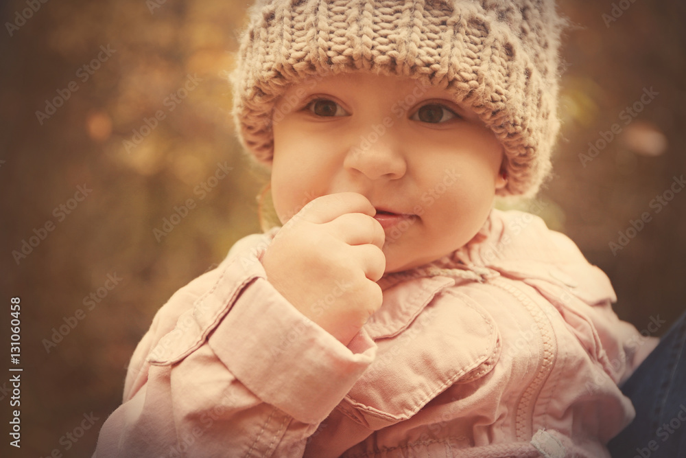 Cute little girl in warm clothes outdoors, close up view