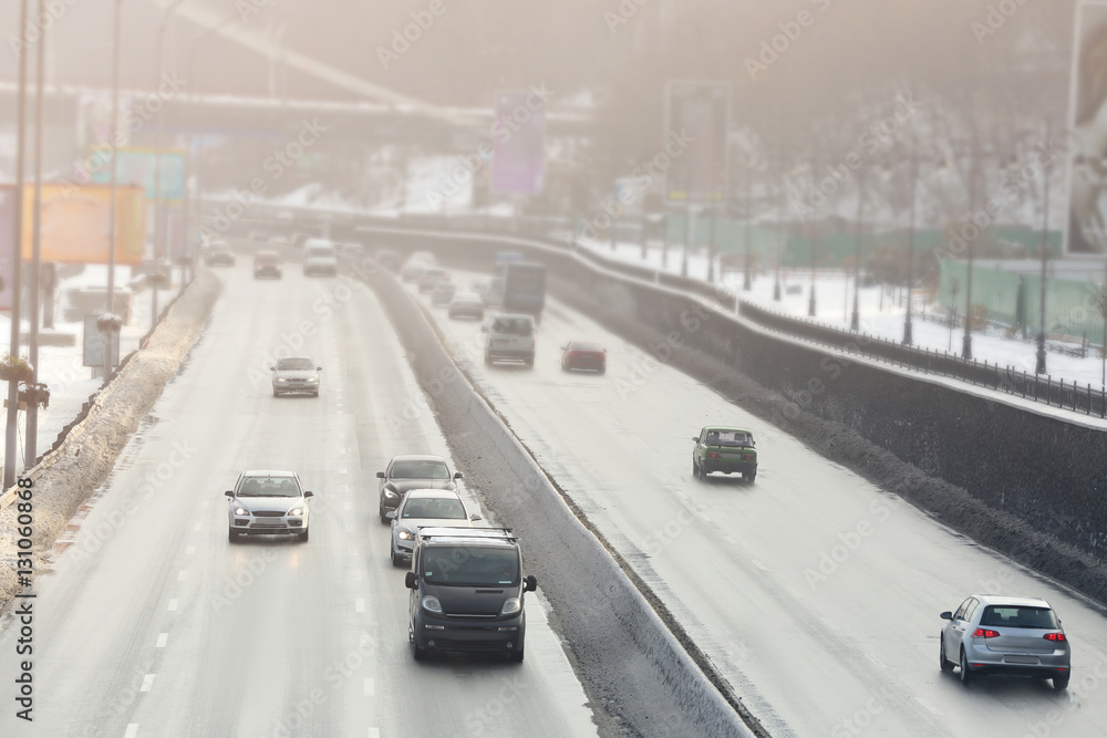 View of city road with cars in winter