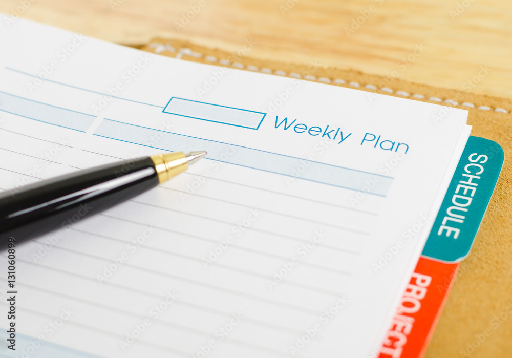 close up shot of daily notebook with pen focus on weekly plan wording business concept close up shot of daily notebook with pen focus on weekly plan wording business concept
