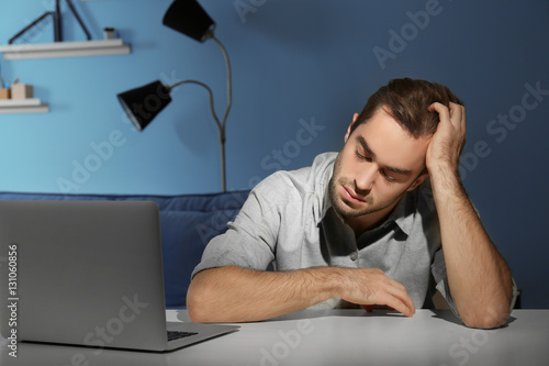 Tired young man working wit...