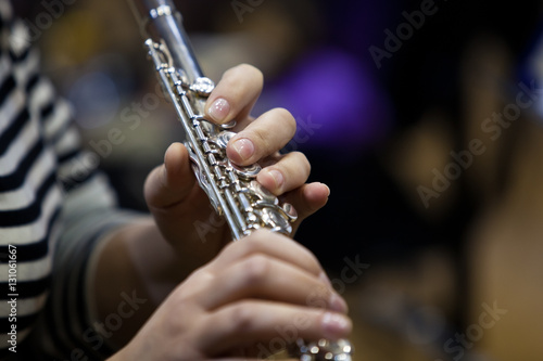 Hands of a woman playing the flute closeup