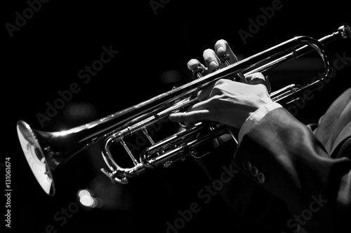 Hands of the musician playing a trumpet closeup in black and white