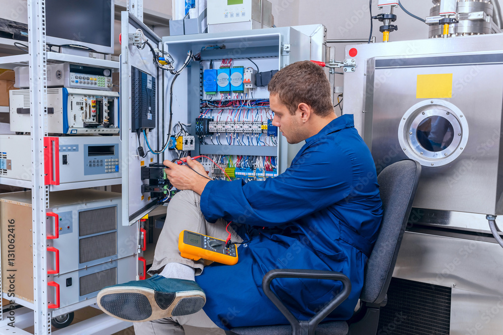 Fototapeta premium Engineer working with digital multimeter in the lab