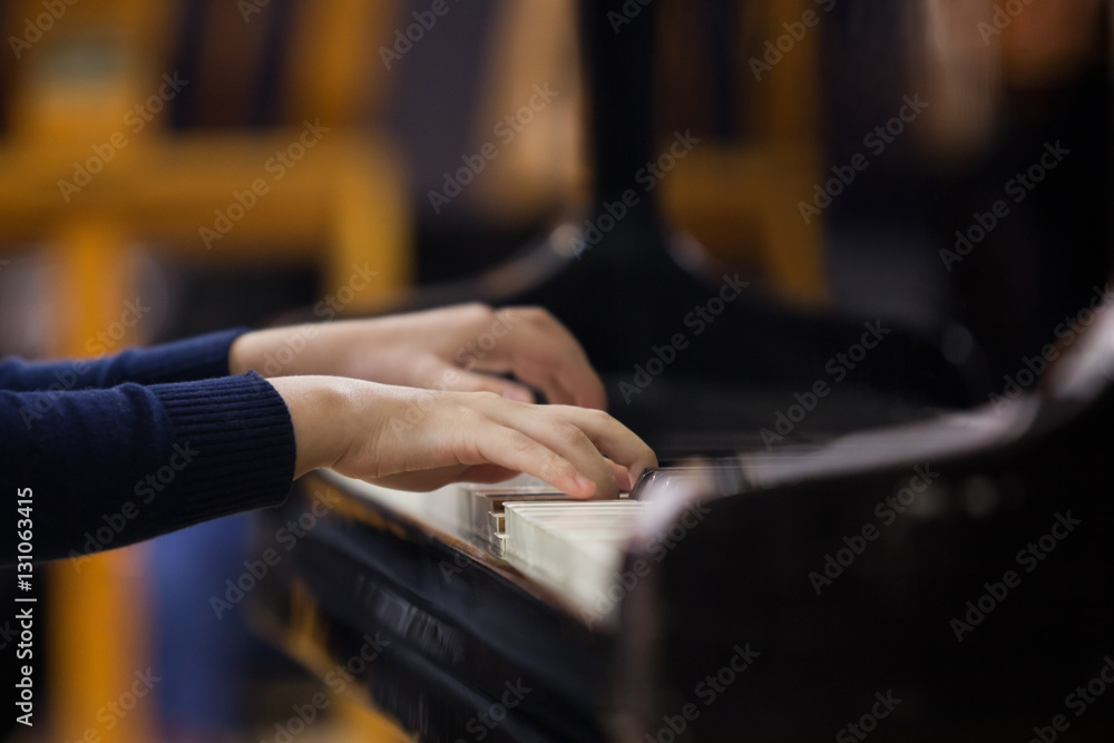Hands of a child playing the piano closeup Hands of a child playing the piano closeup