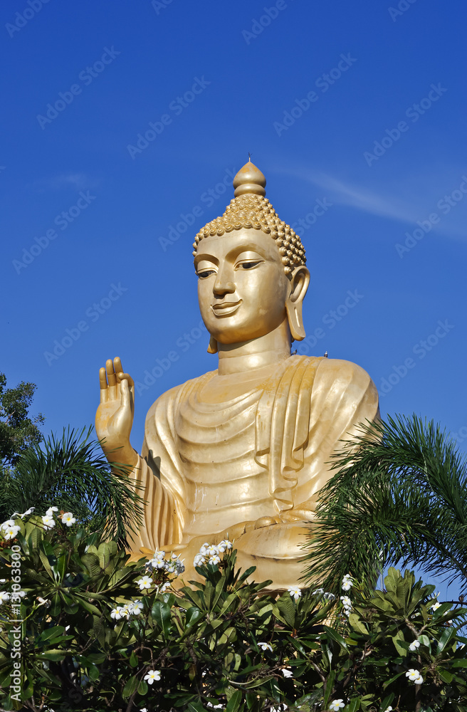golden Buddha in flowers garden