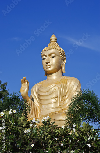 golden Buddha in flowers garden