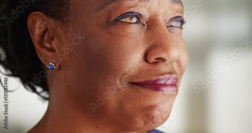 A close-up of an older black woman being very happy. An elderly African American woman happy